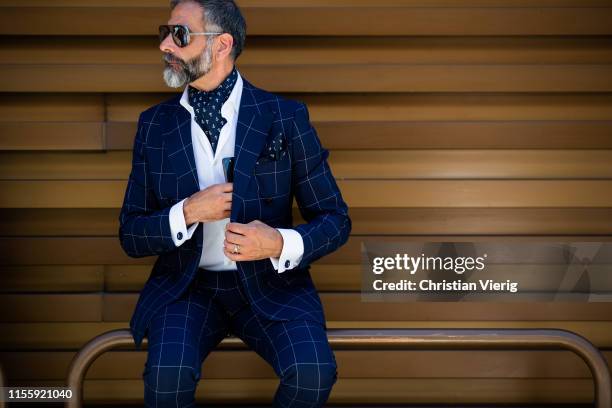 Guests seen wearing plaid navy suit during Pitti Immagine Uomo 96 on June 13, 2019 in Florence, Italy.