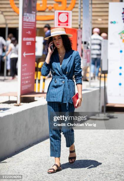 Guest is seen wearing navy striped suit during Pitti Immagine Uomo 96 on June 13, 2019 in Florence, Italy.