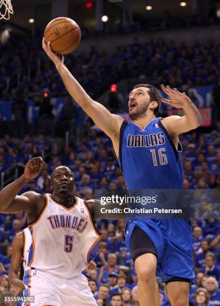Peja Stojakovic of the Dallas Mavericks goes up for a shot against Kendrick Perkins of the Oklahoma City Thunder in Game Four of the Western...