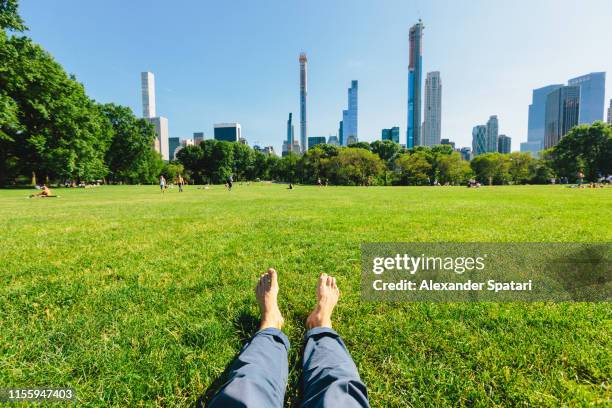 personal perspective of a man relaxing barefoot in central park, new york city - personal perspective view stock pictures, royalty-free photos & images