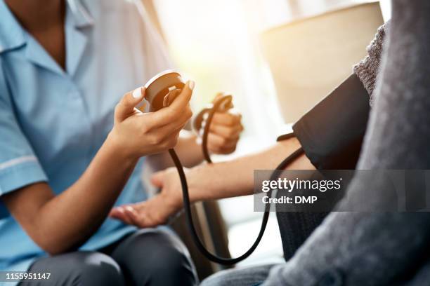 first we'll take a blood pressure reading - visit stock pictures, royalty-free photos & images