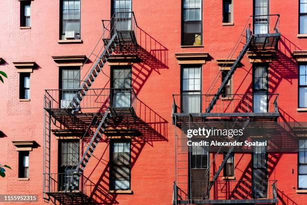 fire escape stairs on buildings in west village district, new york city - soho nueva york fotografías e imágenes de stock