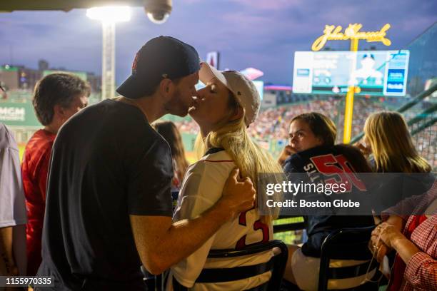 Sam Mewis, midfielder for the U.S. Womens national soccer team, gets a kiss from her husband Pat Johnson after she threw out the first pitch during a...