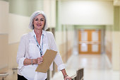 Mature adult school counselor takes break in corridor
