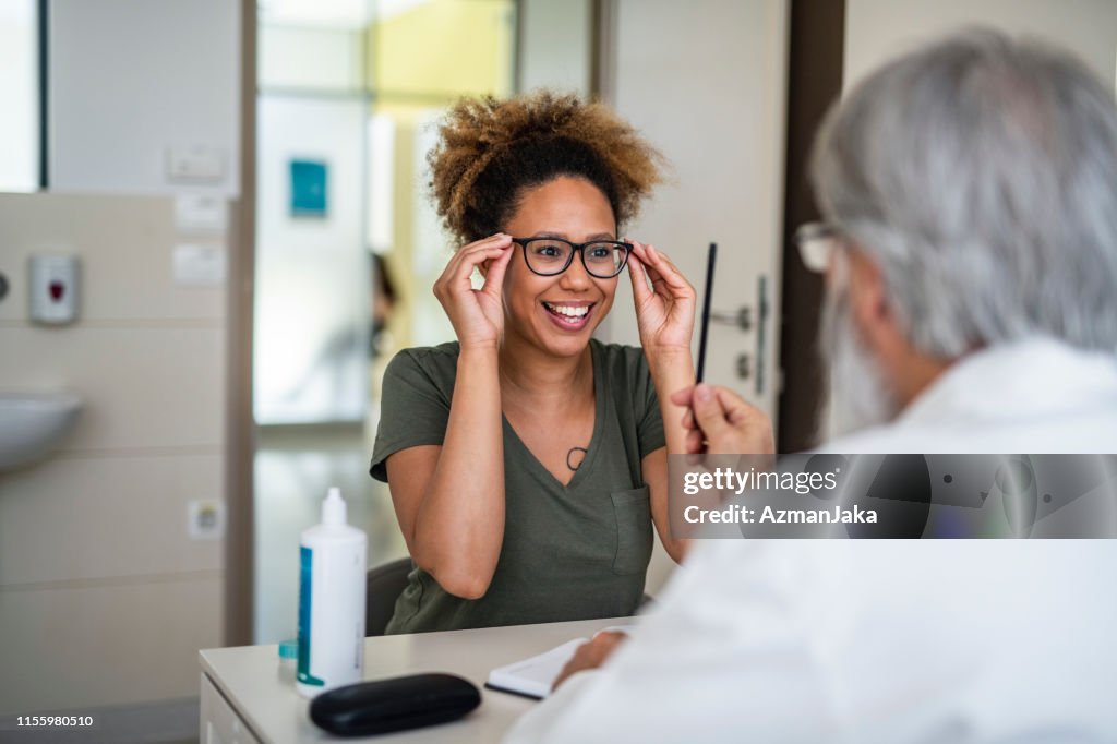 Woman testing out her new eyeglasses in ophthalmology office