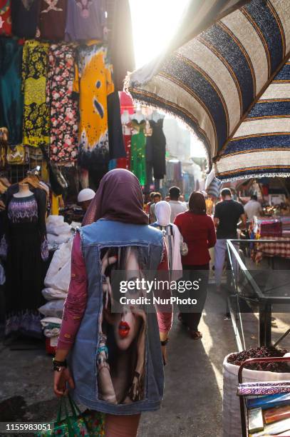 Girl with a curious jacket walk on the street of Khan el Khalil district, Il Cairo, Egypt on 11 July 2019 (photo by (Photo by