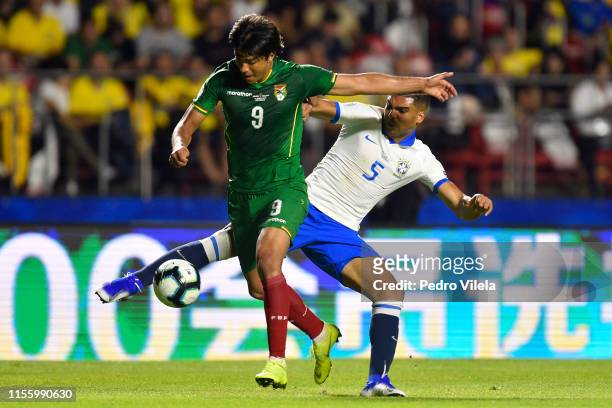 Marcelo Martins of Bolivia fights for the ball with Casemiro of Brazil during a group A match between Brazil and Bolivia at Morumbi Stadium on June...
