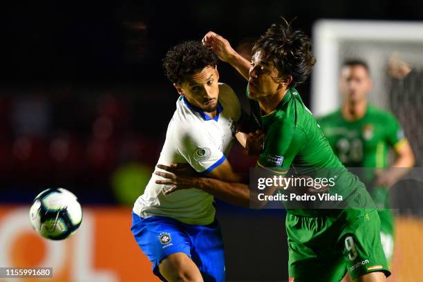 Marquinhos of Brazil fights for the ball with Marcelo Martins of Bolivia during the Copa America Brazil 2019 Opening Ceremony ahead of group A match...