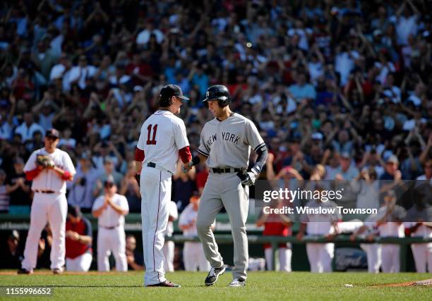 Derek Jeter of the New York Yankees with Clay Buchholz of the Boston Red Sox following the final hit of his career during the third inning against...