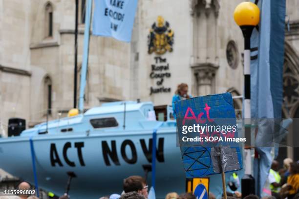 An Extinction Rebellion climate change activists gather outside the Royal Courts of Justice during the protest. Hundreds of Extinction Rebellion...