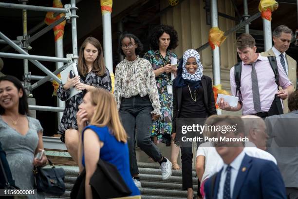 Rep. Ilhan Omara speaks to a reporter as she walks down the steps of the Capitol building after voting for a resolution denouncing comments by...