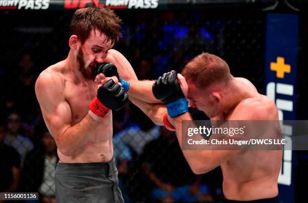 Kevin Syler of Bolivia punches Lance Lawrence in their featherweight bout during Dana White's Contender Series at the UFC Apex on July 16, 2019 in...
