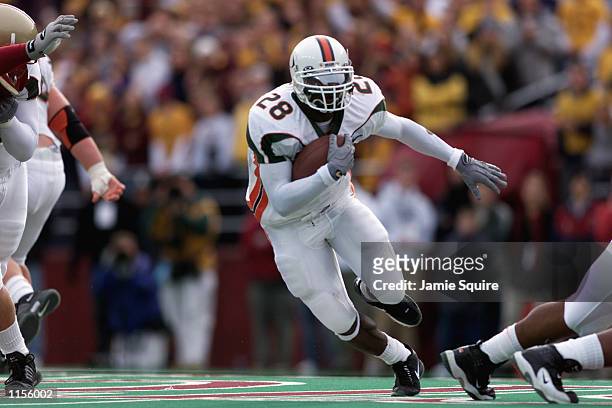 Clinton Portis of the Miami Hurricanes runs with the ball against the Boston College Eagles during the game on November 10, 2001 at Alumni Field in...