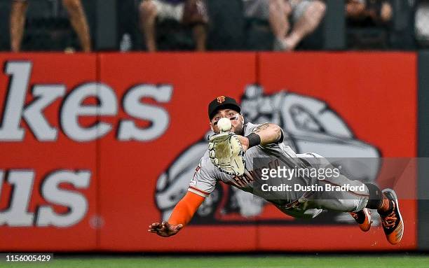 Kevin Pillar of the San Francisco Giants makes a diving catch in center field in the eighth inning against the Colorado Rockies at Coors Field on...