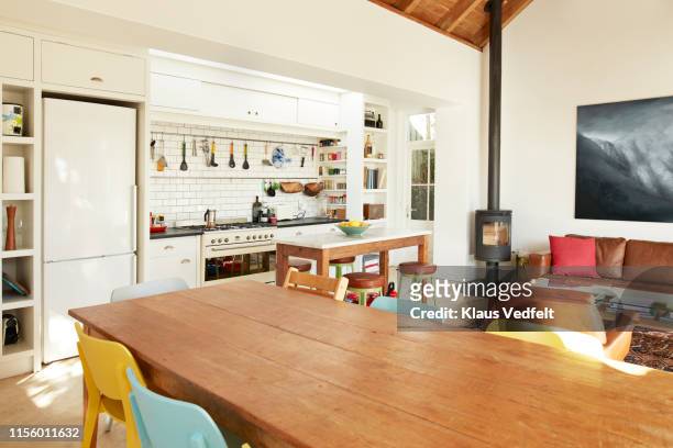 dining table against kitchen counter at home - table stock-fotos und bilder