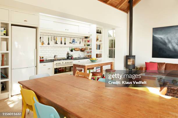 dining table against kitchen counter at home - wood burning stove fotografías e imágenes de stock