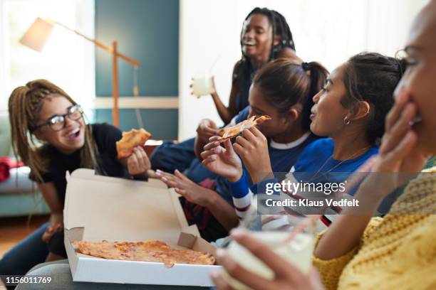 cheerful young women eating fresh pizza - pizza share bildbanksfoton och bilder