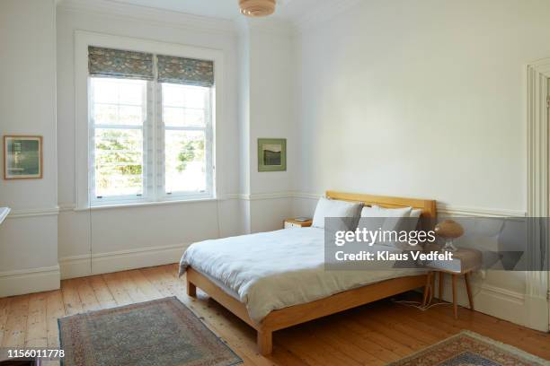 interior of bedroom at home - white bed stockfoto's en -beelden