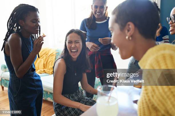 cheerful friends enjoying at home - playing music together stock-fotos und bilder