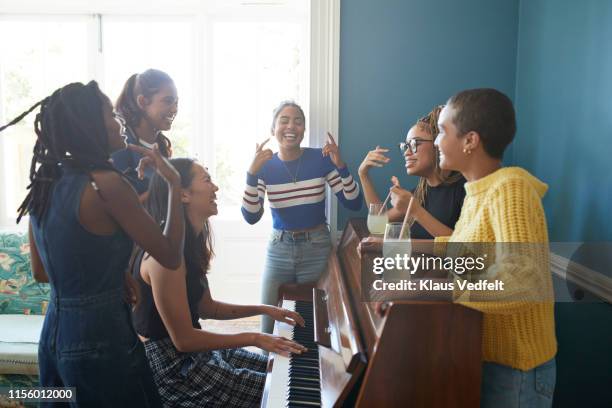 cheerful friends dancing on music - singing group stock pictures, royalty-free photos & images