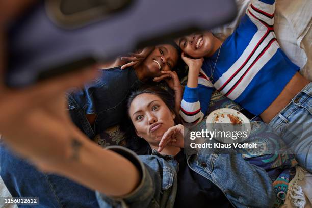 woman puckering while taking selfie with friends - funny selfie stockfoto's en -beelden