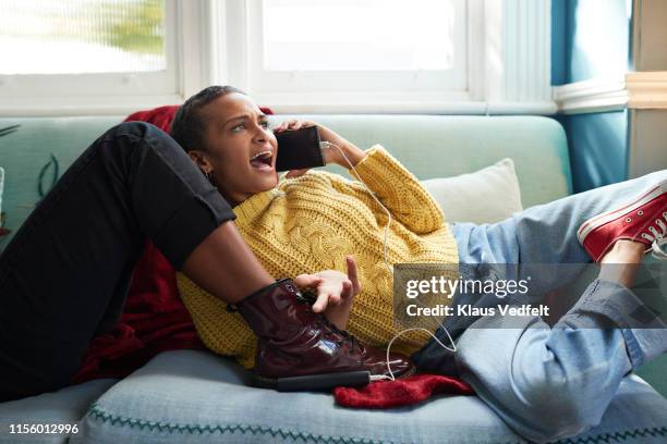 woman with friend shouting on phone at home - friends arguing stock pictures, royalty-free photos & images