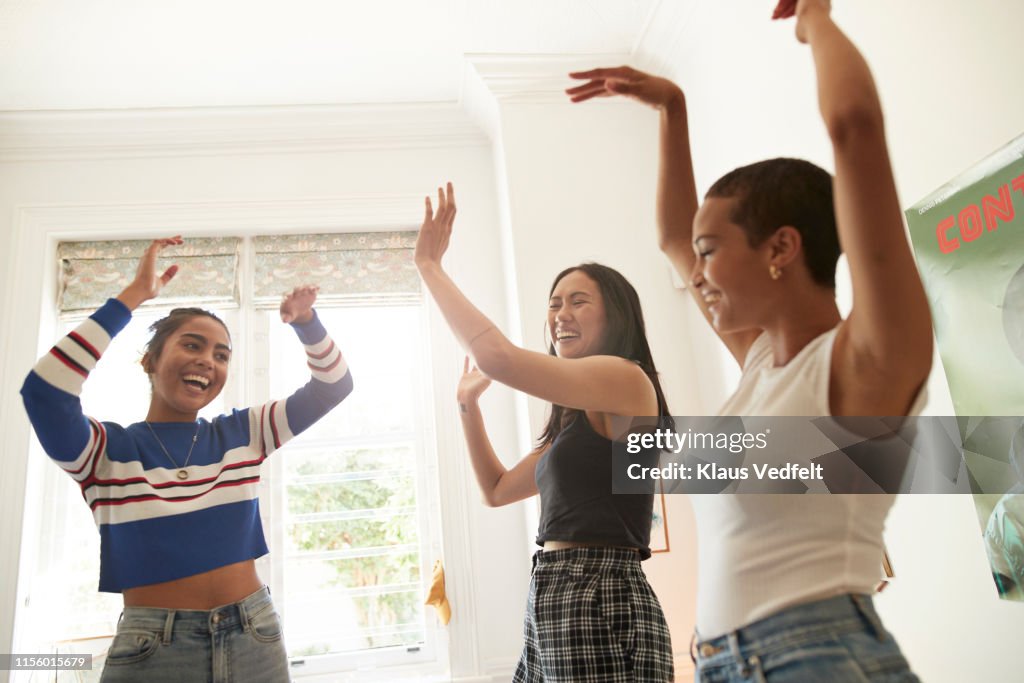 Happy young women dancing enjoying in bedroom