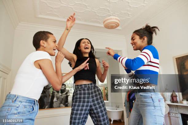 young friends dancing and enjoying in bedroom - woman sing photos et images de collection