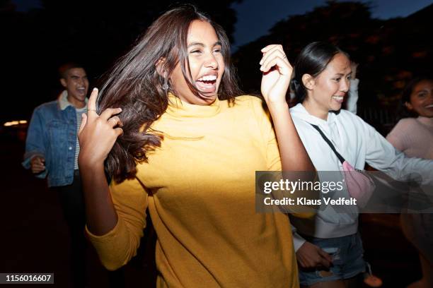 woman enjoying with friends at night - generation z friends stock pictures, royalty-free photos & images