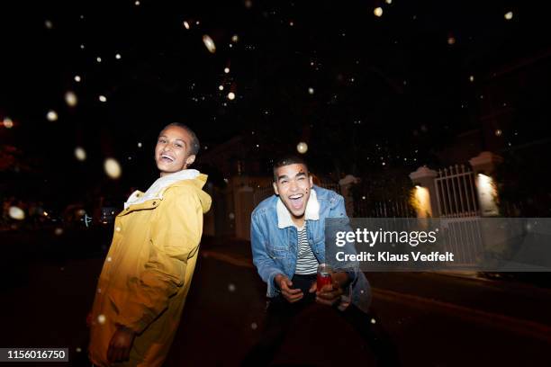 man and woman enjoying on street - ritratto coppia mista foto e immagini stock