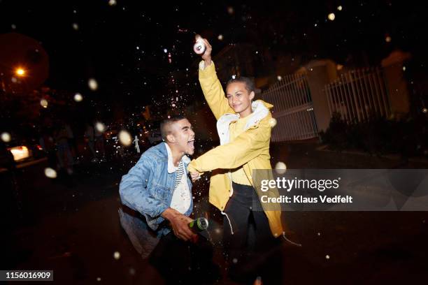 happy man and woman splashing drink - man beer stock pictures, royalty-free photos & images