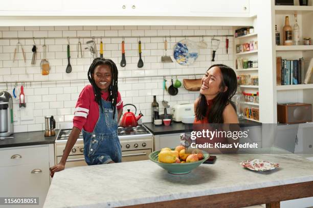 happy friends at kitchen island - woman table standing stock pictures, royalty-free photos & images