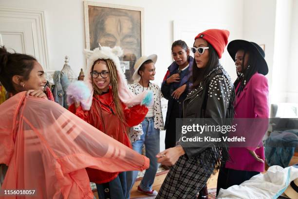 smiling multi-ethnic friends wearing clothes in bedroom - party preparation stock pictures, royalty-free photos & images