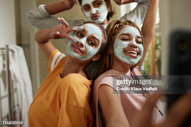 happy woman taking selfie with friends wearing cream - sleepover bildbanksfoton och bilder