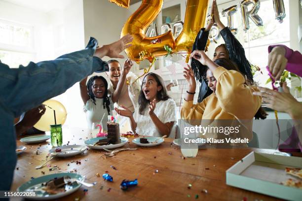 friends cheering for woman in birthday party - birthday party stockfoto's en -beelden