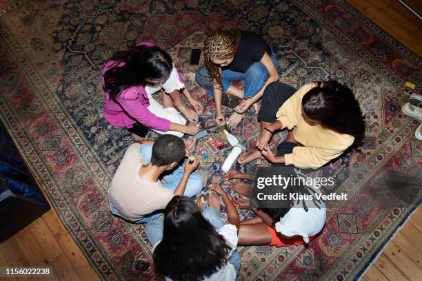 friends painting nails at slumber party - black painted toes stock pictures, royalty-free photos & images