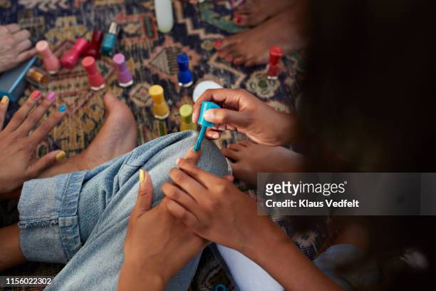woman applying nail polish to friend - friends women makeup ストックフォトと画像