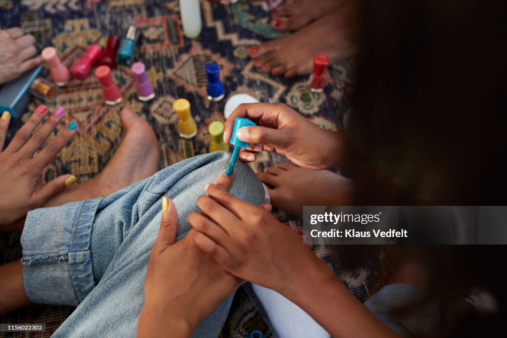 Woman applying nail polish to friend