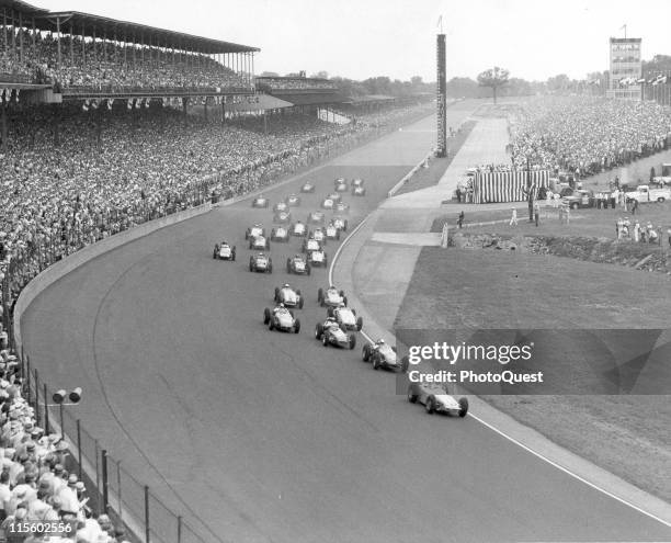 High-angle view of cars as they approach a curve in the track at the Indianapolis Speedway race track, Speedway, Indiana, 1960.