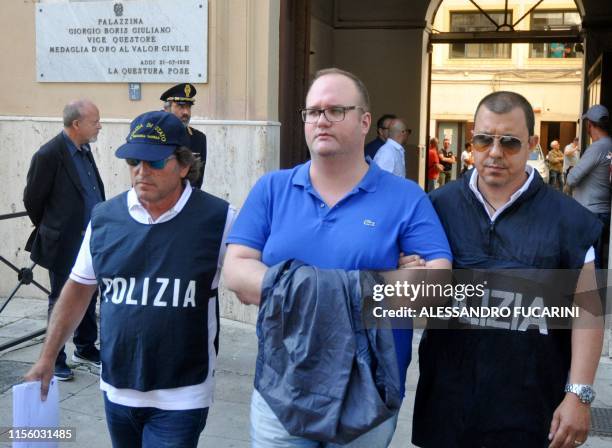 Italian police officers escort Salvatore Gambino after he was arrested in Palermo during an police/FBI operation called 'New Connection' on July 17,...