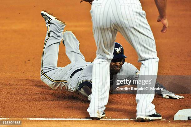 Yuniesky Betancourt of the Milwaukee Brewers slides into third base during a MLB game against the Florida Marlins at Sun Life Stadium on June 6, 2011...