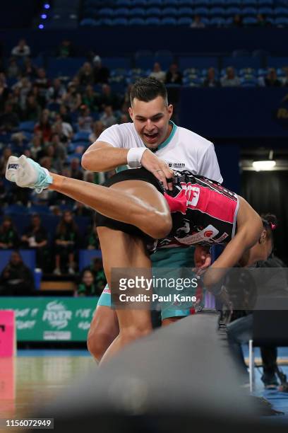 Umpire Tim Marshall assists Shamera Sterling of the Thunderbirds during the round 8 Super Netball match between the Fever and the Thunderbirds at RAC...