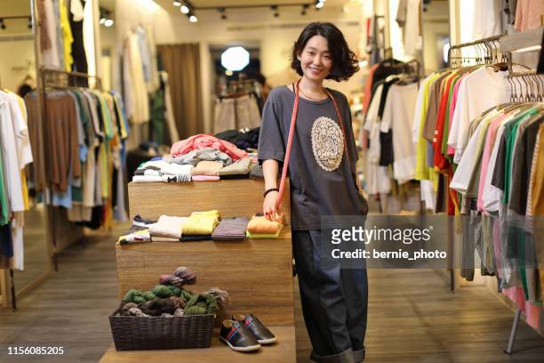 young woman business owner in a clothes shop, portrait - taiwan business stock pictures, royalty-free photos & images