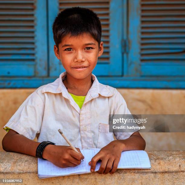 cambodian schoolboy doing homework near tonle sap, cambodia - cambodia stock pictures, royalty-free photos & images