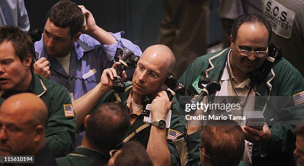 Traders work in the crude oil options pit during afternoon trading at the New York Mercantile Exchange June 8, 2011 in New York City. Oil prices rose...