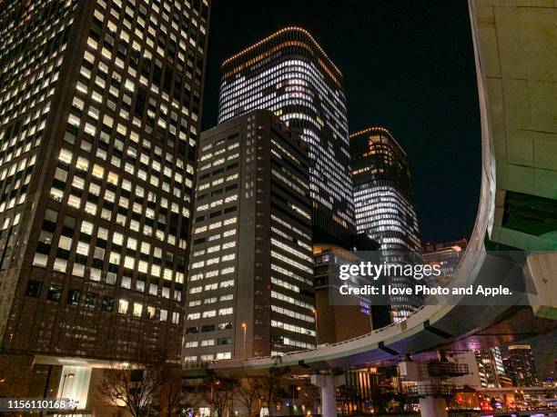 night view of downtown osaka along the dojima river - 大阪市 stock-fotos und bilder