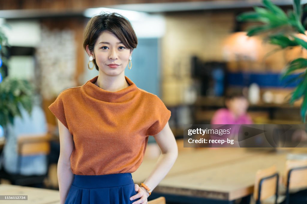 Portrait of young business woman in modenr co-working space