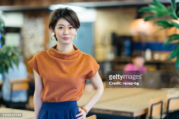 portrait of young business woman in modenr co-working space - japanese woman stock pictures, royalty-free photos & images