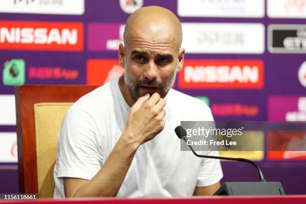 Pep Guardiola , manager of Manchester City speaks during a press conference during Premier League Asia Trophy - West Ham United v Manchester City on...