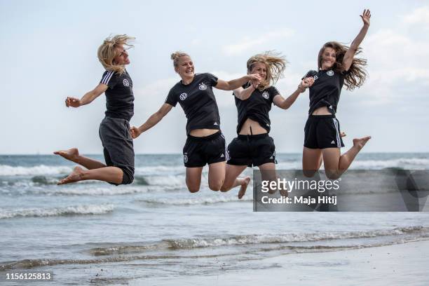 Kathrin Hendrich , Leonie Maier, Verena Schweers and Sara Daebritz pose for a photo as team of Germany visits the beach on June 15, 2019 in La...